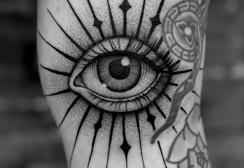 Eye tattoos on the backs of two legs